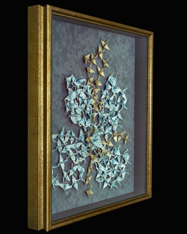 Side view of origami cranes picture framing