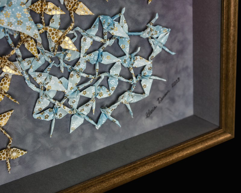 Detail view of origami cranes picture framing